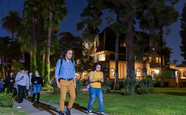 Students walking on Campus at night.