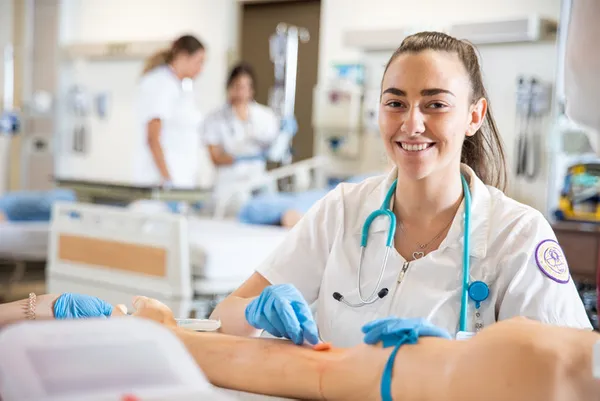 Nursing student practicing on a mannequin