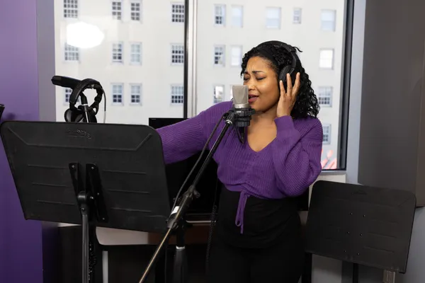Student recording in recording booth