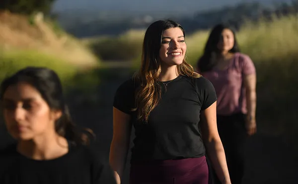 Students hiking and smiling