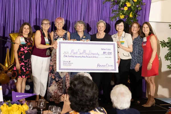 reunion group holding a check for donation