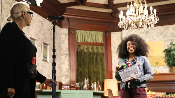 Woman holding a clapper on set