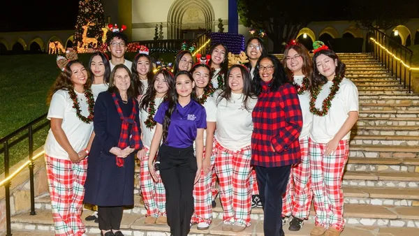 President Ann McElaney-Johnson, PhD (front row, second from left), Vice President for Student Affairs Linda McMurdock, PhD (front row, third from right), and SAC President Jettina Krantz ’27 (center, in purple) join members of Pangkat Pilipino in celebrating Lighting of the Circle.