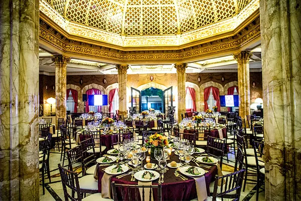 indoor event space with tables and chairs set up