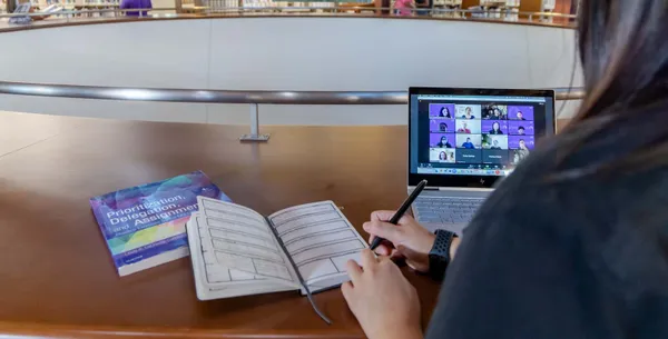 Student studying online in library