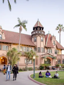 students walking in front of doheny mansion