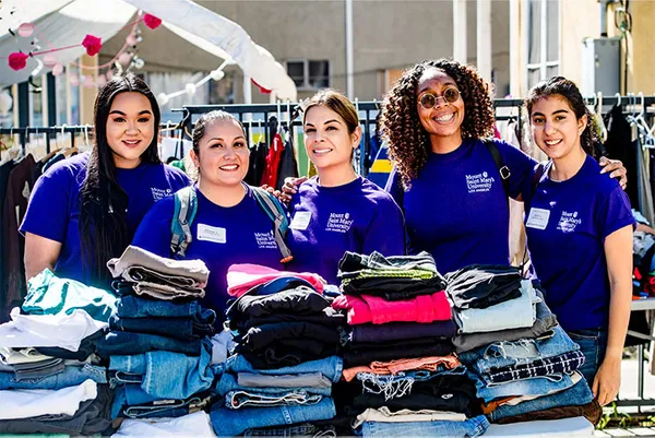 students in purple MSMU shirts smiling together