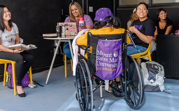 Students sitting around a table studying in the shade
