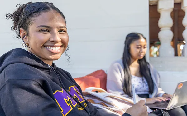 A student smiling at the Chalon Campus.