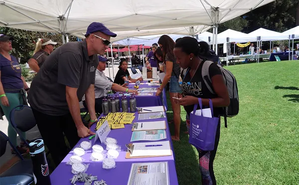 Students speaking with booth attendants about different clubs and organizations at MSMU.