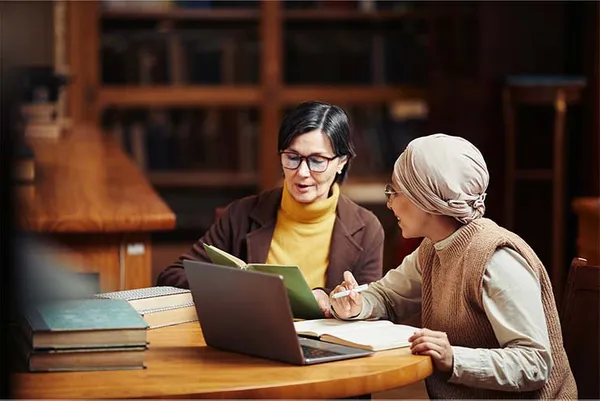 two women working together at a table