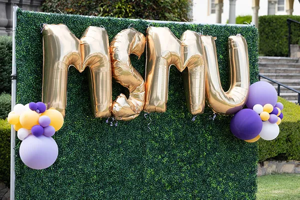 MSMU letter balloons on hedge