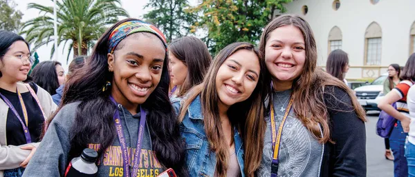 3 students smiling wearing MSMU gear