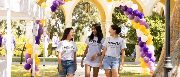 Three students walking on chalon campus at orientation