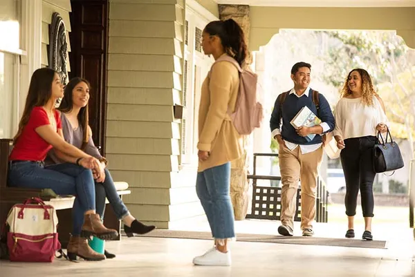 students sitting and walking chatting on campus