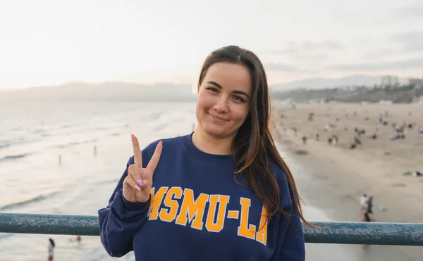 A MSMU student giving a peace sign on the LA Pier