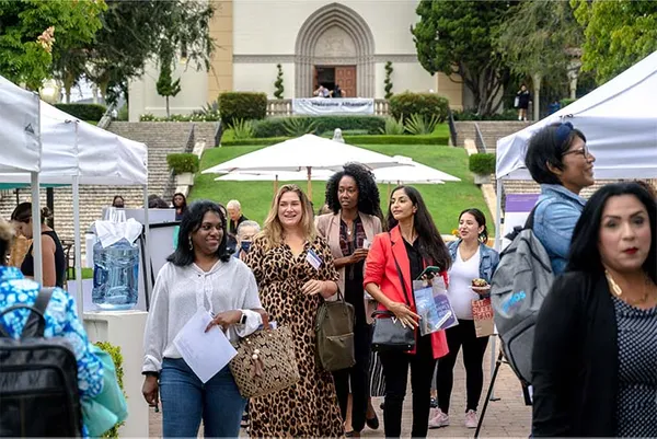 women walking at event on campus