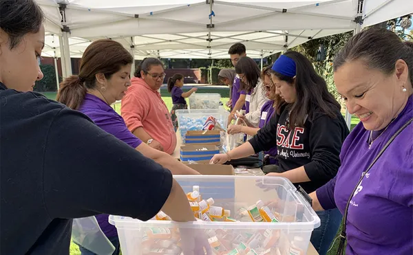 Students filling bags with soap and other supplies.