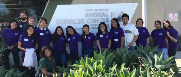 A group photo of MSMU students standing in front the sign for Animal Services Center in LA.